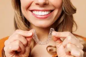 Woman putting on her clear aligners